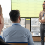 Key Factors to Consider Before Enrolling in a Training Program A man presenting to an audience, engaging with the group while using visual aids.